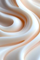 Smooth creamy white swirls create elegant flowing curves and waves in soft peach and ivory tones, suitable for cosmetic and beauty product marketing backgrounds.