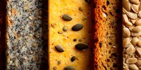 Assortment of artisanal bread slices with various seeds and grains, showing texture and variety in baking. Perfect for food marketing.