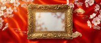 Ornate golden frame on red silk fabric with cherry blossoms and traditional Asian patterns for luxury decoration and elegant presentation displays.