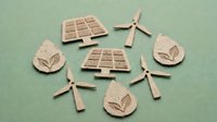 Cardboard cutout icons of solar panels, wind turbines, and eco drops arranged on green background, representing renewable energy and sustainability.