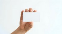 Caucasian male hand holding blank white business card against neutral background for branding and corporate identity mockups.