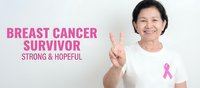 Mature Asian woman breast cancer survivor showing victory sign with pink ribbon symbol representing hope, strength and awareness campaign.