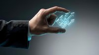 Businessman hand holding glowing holographic building blueprint, representing digital architecture, construction technology, and innovative engineering solutions for modern development projects.