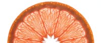 Sliced grapefruit or orange citrus fruit half showing fresh pulp segments and natural texture for food and beverage design.