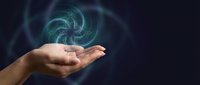 Human hand holding glowing green digital spiral energy hologram against dark background for technology and innovation concepts.
