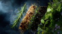 Fresh aromatic herbs and spices on dark background with dramatic lighting and smoke effects, culinary concept for restaurant menu and food photography.