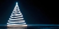 Light painting Christmas tree made with long exposure photography on dark blue background with star on top for holiday greeting cards and decorations.