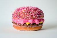 Pink sprinkled burger bun with melted cheese, beef patty and strawberry cream sauce on white background, isolated food photography for menu design.