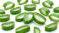 Fresh cucumber slices with water droplets isolated on white background, ready for culinary, food styling, recipe, and healthy eating design projects.