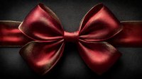 Elegant burgundy satin ribbon bow with glossy finish on dark textured background for luxury gift wrapping and festive decoration projects.