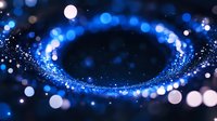 Glowing blue spiral of light particles and bokeh effects on dark background creates magical atmosphere for festive or cosmic design projects.