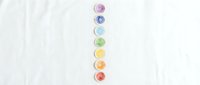 Isolated watercolor paint circles in rainbow gradient arranged vertically on white background, ready for design projects, educational materials, art tutorials, and creative compositions.