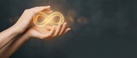 Hands holding glowing infinity symbol representing endless possibilities, eternal concepts, and limitless potential for business and personal growth.