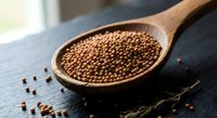 Coriander seeds in wooden spoon on dark slate surface. Organic spice ingredient for cooking and seasoning. Natural aromatic condiment for culinary use.