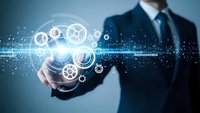 Professional businessman holding glowing digital gears and technology interface with futuristic holographic elements for innovation concepts.