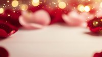 Festive holiday background with warm golden bokeh lights and red decorations creating magical Christmas atmosphere for seasonal marketing and greeting cards.