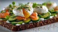 Gourmet open sandwich with poached egg, smoked salmon, cucumber and fresh dill on dark bread for breakfast menu and healthy eating concepts.