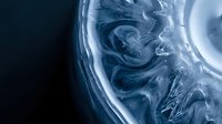 Abstract blue liquid swirls in glass creating dynamic fluid motion patterns for modern design backgrounds and creative projects.