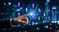 Business hand touching digital network of people icons with justice scales in hexagonal interface against city lights background for HR management.
