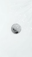 Silver cryptocurrency coin on minimalist white background with digital network pattern for fintech and blockchain technology concepts.