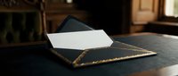 Elegant black leather portfolio with gold trim holding white paper documents on dark surface in warm office setting for business presentations.