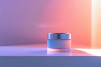 Luxury cosmetic cream jar on gradient background with soft purple and coral lighting, minimal product photography for beauty and skincare advertising.