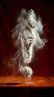 White flour explosion bursting upward from wooden surface creating dramatic cloud of powder particles against dark red background.