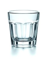 Empty classic rocks glass with faceted design isolated on white background, showing crystal clear transparency and geometric patterns for beverage photography.