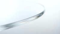 Abstract curved glass surface with soft translucent edges creating elegant flowing lines on white background for modern design projects.