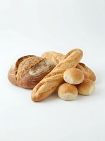 Assorted fresh baked bread loaves and rolls isolated on white background, ready for bakery, food service, or culinary design projects.