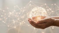 Hands holding glowing globe with digital network connections, representing global communication, technology innovation, and worldwide data connectivity for business solutions.