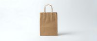 Brown kraft paper shopping bag with handles isolated on white background, ready for packaging design, branding mockups, retail presentations, and e-commerce applications.