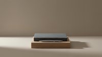 Slate stone slab resting on wooden base against neutral beige background, minimalist home decor and interior design element.
