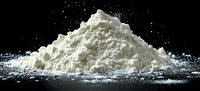 White powder substance heap against black background with scattered particles, suitable for food industry, pharmaceutical, or chemical concept illustrations.
