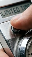 Finger pressing button on metallic timer displaying limited time text, closeup macro shot for deadline, urgency and countdown concepts.