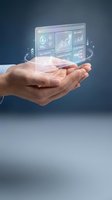 Businessman holding holographic dashboard with analytics charts, graphs and financial data visualization for business intelligence and digital technology concepts.