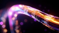 Glowing fiber optic cable with orange and purple light effects against dark background shows digital data transmission and network connectivity concept.