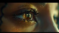 Extreme close-up of brown eye with golden light reflection, long eyelashes and detailed iris texture captured in dramatic cinematic lighting style.