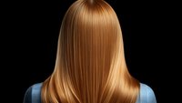 Back view of straight blonde hair on black background showing smooth, glossy texture and professional salon styling result for beauty and haircare advertising.