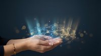 Female hands presenting glowing hexagonal network structure with light beams and bokeh effects on dark background for technology presentations.