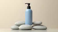 Light blue cosmetic pump bottle on zen stones against neutral beige background, minimalist spa and wellness composition for beauty product presentation.
