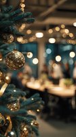 Gold ornament hanging on Christmas tree with blurred festive restaurant interior and warm bokeh lights in background.