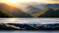 Dramatic mountain landscape at golden sunset with stone surface in foreground, creating depth and perspective for nature photography and outdoor adventure themes.