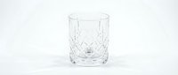 Crystal cut glass tumbler with diamond pattern on white background isolated for luxury drinkware and barware design projects.