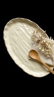 Cream ceramic serving dish with wooden spoon and dried flowers, isolated on transparent background. Ready for kitchen design, home decor clipart, print-on-demand products, sublimation, and t-shirt designs.