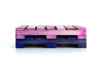 Colorful wooden pallets stacked on white background, painted in pink, purple and blue shades. Industrial design element isolated and ready for creative use.