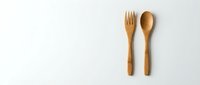 Wooden fork and spoon utensils isolated on white background for eco-friendly kitchen design and sustainable dining concepts.