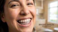 Young Hispanic woman with metal braces smiling happily in dental office showing orthodontic treatment progress for teeth straightening and oral health care.