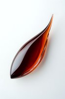 Elegant amber glass leaf-shaped bowl isolated on white background for modern home decor and artistic display purposes.