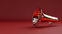Metallic red megaphone with reflective surface lying on red background. Modern minimalist marketing and communication concept with dramatic lighting.